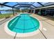 A large pool with a screened-in enclosure and lake view at 4216 Bur St, Port Charlotte, FL 33948