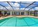 The home features a screened pool and a lake view at 4216 Bur St, Port Charlotte, FL 33948