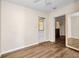 Bright bedroom with wood-look floors and an exterior access door at 426 Burland St, Punta Gorda, FL 33950