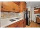 Kitchen featuring wooden cabinetry, laminate countertops, and stainless steel appliances at 426 Burland St, Punta Gorda, FL 33950