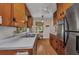 Galley kitchen with wood cabinets, white countertops, and vintage accents at 426 Burland St, Punta Gorda, FL 33950
