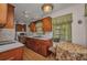 Charming kitchen with wooden cabinets and a cozy dining area by the window at 426 Burland St, Punta Gorda, FL 33950