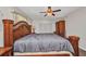 The main bedroom features a ceiling fan, double-door closet, and large ornamental wood bed frame at 426 Burland St, Punta Gorda, FL 33950