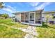 Screened-in patio offering an outdoor space with comfortable furniture, a grill, and views of the lush backyard at 426 Burland St, Punta Gorda, FL 33950