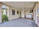 Covered patio with washer and dryer hookups, small television, and access to the backyard at 426 Burland St, Punta Gorda, FL 33950