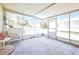 Screened-in porch with tiled floor and view of the backyard, and a chair and small table at 426 Burland St, Punta Gorda, FL 33950