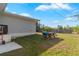 Spacious backyard with a picnic table, BBQ grill, and exterior of the house at 4702 Westwood Dr, Punta Gorda, FL 33982