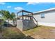 A backyard featuring an above-ground pool with a deck and a wooden fence, set against a blue sky at 4702 Westwood Dr, Punta Gorda, FL 33982