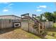 Backyard featuring a small deck with stairs, an above ground pool, and grass at 4702 Westwood Dr, Punta Gorda, FL 33982