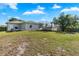 Large grassy backyard with a trampoline and some shade from mature trees at 4702 Westwood Dr, Punta Gorda, FL 33982