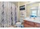 This bathroom features a shower, decorative curtain, nice mirror and a vanity with great lighting at 4702 Westwood Dr, Punta Gorda, FL 33982