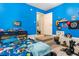 This bedroom features bright blue walls, a bed, some exercise equipment and an open door at 4702 Westwood Dr, Punta Gorda, FL 33982