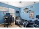 A comfortable bedroom featuring a cozy bed, shelves, desk, and window with natural light at 4702 Westwood Dr, Punta Gorda, FL 33982