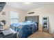 This bedroom offers a serene retreat with a plush bed, large window, and dark wood mirror at 4702 Westwood Dr, Punta Gorda, FL 33982