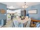 Charming dining area with a kitchen view, featuring a farmhouse-style table set and classic appliances at 4702 Westwood Dr, Punta Gorda, FL 33982