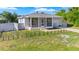 Inviting single-story home with a screened porch, driveway, and fenced front yard at 4702 Westwood Dr, Punta Gorda, FL 33982