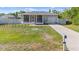 Charming single-story home with a screened-in porch, driveway, and well-maintained lawn and minimal landscaping at 4702 Westwood Dr, Punta Gorda, FL 33982