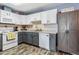 Well-lit kitchen featuring white cabinets, sleek countertops, and modern appliances at 4702 Westwood Dr, Punta Gorda, FL 33982