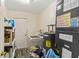 This laundry room features a washing machine, water heater, shelves and access to a door at 4702 Westwood Dr, Punta Gorda, FL 33982