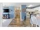 Open-concept living and dining area with modern floors, calming blue walls, and cozy furnishings at 4702 Westwood Dr, Punta Gorda, FL 33982