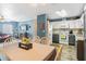 Open-concept living space combines living, dining, and kitchen areas with wood look floors and modern decor at 4702 Westwood Dr, Punta Gorda, FL 33982