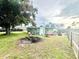 Large, fenced backyard with lush greenery, fire pit, and space for recreation and relaxation at 481 Reading Nw St, Port Charlotte, FL 33952