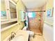 Well-lit bathroom with a tiled shower, vanity with storage, and a clean, modern aesthetic at 481 Reading Nw St, Port Charlotte, FL 33952