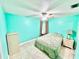 Bedroom with turquoise walls, tile floor, ceiling fan, and neutral-colored furniture and decor at 481 Reading Nw St, Port Charlotte, FL 33952