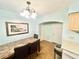 Dining room with a marble table, seating for four, elegant chandelier, and arched doorway at 481 Reading Nw St, Port Charlotte, FL 33952
