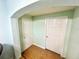 Hallway with tiled floors and two white doors under an arched doorway at 481 Reading Nw St, Port Charlotte, FL 33952