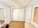 Hallway with multiple doors, tiled floor, and natural light from a nearby window at 481 Reading Nw St, Port Charlotte, FL 33952