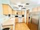 Functional kitchen featuring tile flooring, wood cabinets, stainless steel appliances, and a ceiling fan at 481 Reading Nw St, Port Charlotte, FL 33952