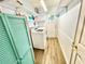 Bright laundry room with storage shelves, a washer, and a dryer near an exterior door at 481 Reading Nw St, Port Charlotte, FL 33952