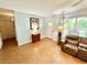 Inviting living room featuring tile floors, comfortable seating, natural light, and an adjacent doorway at 481 Reading Nw St, Port Charlotte, FL 33952