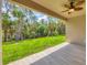 Covered back porch offering a serene view of the lush backyard and mature trees at 4862 Kiska Rd, North Port, FL 34288