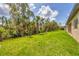 Expansive backyard with lush green grass and a variety of mature trees at 4862 Kiska Rd, North Port, FL 34288
