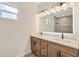 Contemporary bathroom with a double sink vanity, modern lighting, and a glass-enclosed shower at 4862 Kiska Rd, North Port, FL 34288