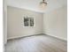 Cozy bedroom with a comfortable bed, modern lighting, and a bright window at 4862 Kiska Rd, North Port, FL 34288