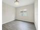 Cozy bedroom featuring wood-look floors, chandelier, and a window for natural light at 4862 Kiska Rd, North Port, FL 34288