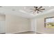 Neutral bedroom featuring a ceiling fan, a large window, and neutral colored walls at 4862 Kiska Rd, North Port, FL 34288