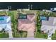 Aerial view of waterfront home with private pool, lush landscaping, and boat dock at 5023 Key Largo Dr, Punta Gorda, FL 33950