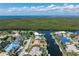 Aerial view showcasing the waterfront property, pool, boat dock and lush surroundings at 5023 Key Largo Dr, Punta Gorda, FL 33950