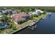 Waterfront home featuring a private dock, canal access, and lush landscaping at 5023 Key Largo Dr, Punta Gorda, FL 33950