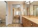 Bathroom featuring a vanity, mirrored closet, and a separate area with a soaking tub and glass-enclosed shower at 5023 Key Largo Dr, Punta Gorda, FL 33950
