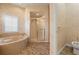 Comfortable bathroom showcasing a bathtub, shower with glass doors, and a toilet, accented with neutral decor at 5023 Key Largo Dr, Punta Gorda, FL 33950