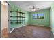 Cozy bedroom with wood floors, shelves, and window offering natural light, creating a serene and inviting space at 5023 Key Largo Dr, Punta Gorda, FL 33950
