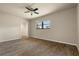 Spacious bedroom with walk-in closet, wood-look floors, and ceiling fan at 5023 Key Largo Dr, Punta Gorda, FL 33950