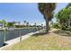 Well-maintained dock on canal with lush landscaping and a clear blue sky at 5023 Key Largo Dr, Punta Gorda, FL 33950