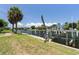 Private boat dock with lift on a canal, surrounded by mature palm trees and landscaping at 5023 Key Largo Dr, Punta Gorda, FL 33950