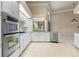 Kitchen with stainless steel appliances, tiled flooring, and lots of natural light at 5023 Key Largo Dr, Punta Gorda, FL 33950